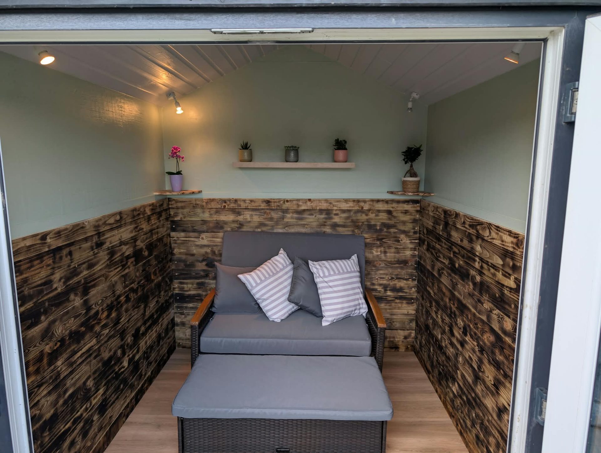 Garden room interior with charred timber cladding and lighting in Cornwall