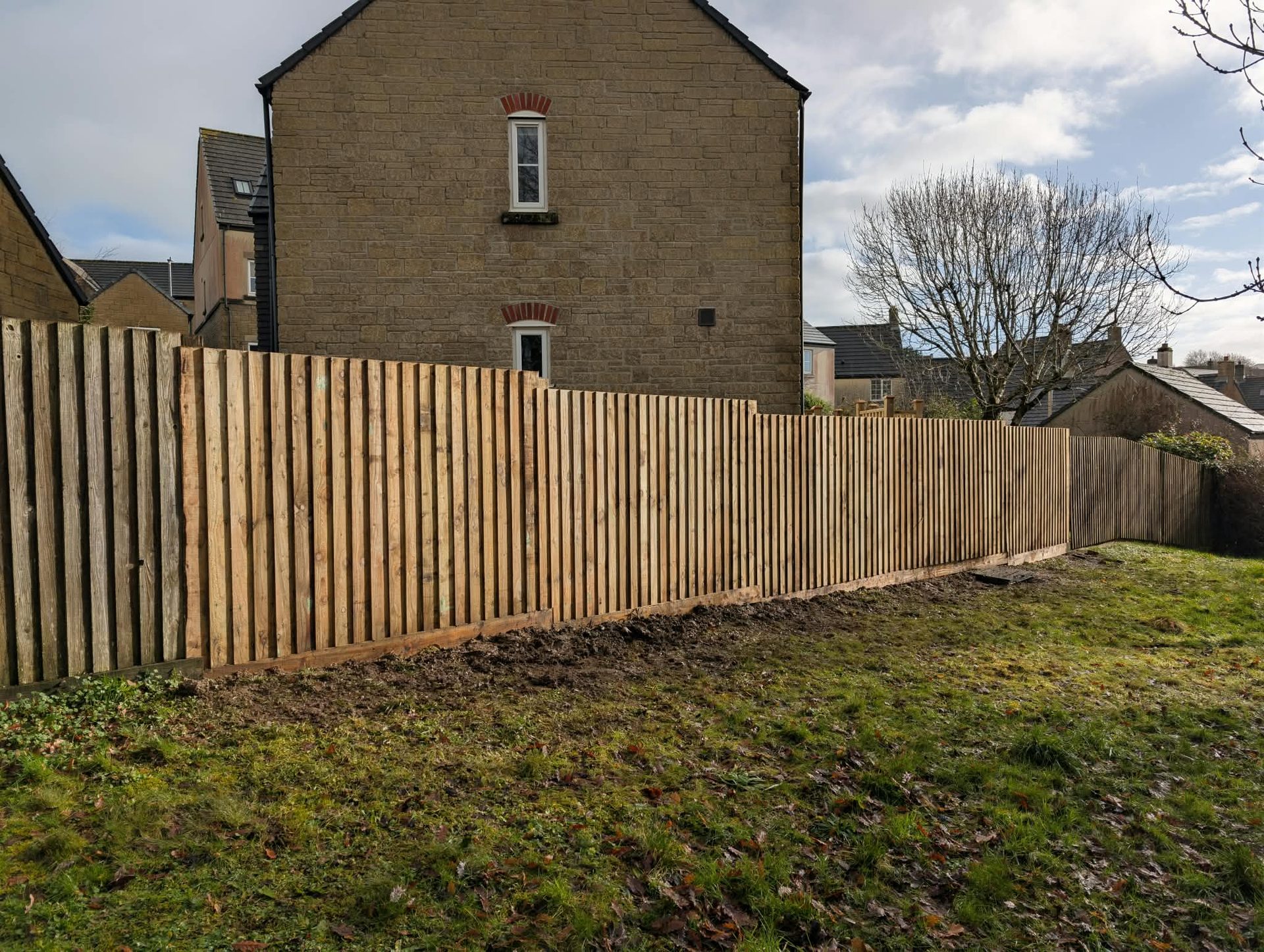 New close-board timber boundary fence beside a lawn in Cornwall